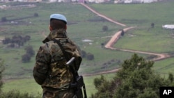 FILE - A Spanish U.N. peacekeeper looks to the U.N-demarcated Blue Line border between Lebanon and Israel, Feb. 24, 2015.
