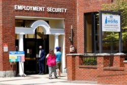 FILE - Job seekers enter the New Hampshire Works employment security center, May 10, 2021, in Manchester. States are pushing the unemployed to get back to work to help businesses find the workers they need to emerge from the COVID recession.