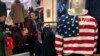 FILE - A woman tries out a sweater at U.S. retailer GAP's flagship store in Beijing, Jan. 10, 2019.