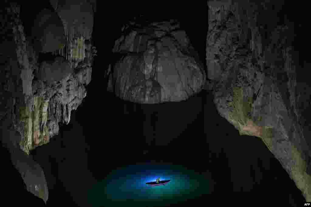 A visitor takes part in a tour in Son Doong cave, one of the world's largest natural caves, in central Vietnam's Quang Binh province.