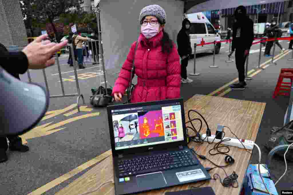 People arrive to watch the New Years countdown concert in Taipei, Taiwan, Dec. 31, 2020.