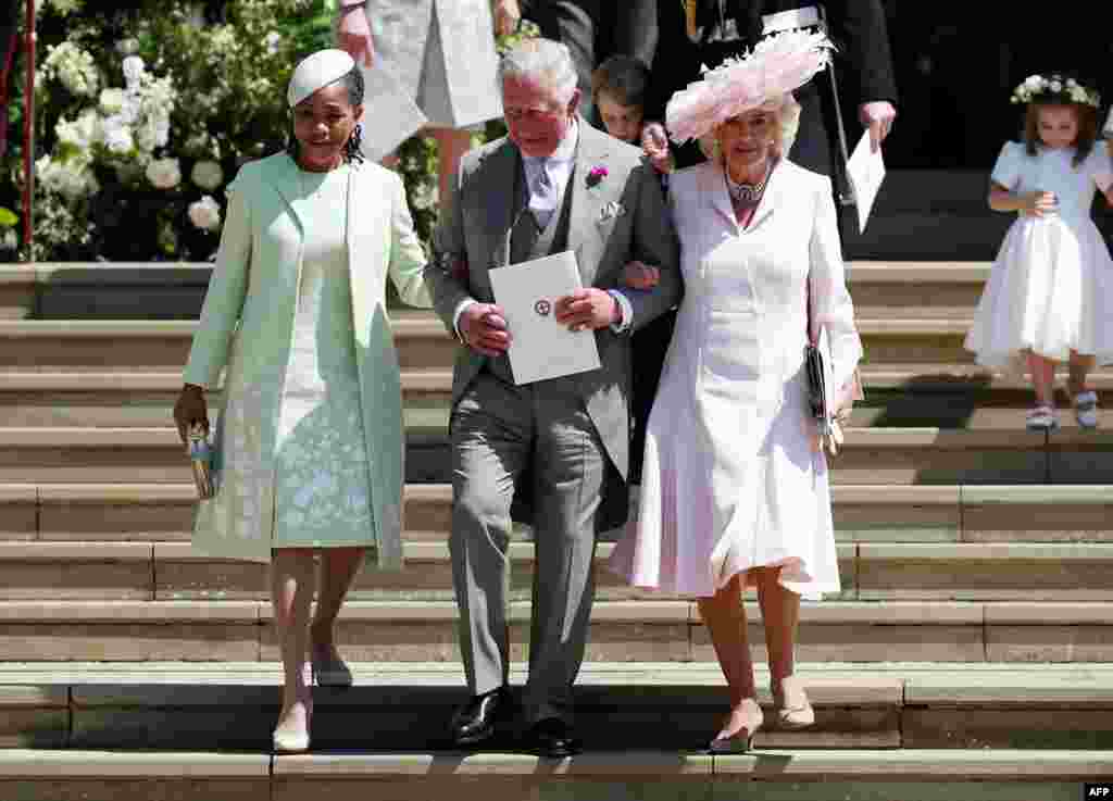 (L-R) Meghan Markle's mother Doria Ragland, Britain's Prince Charles, Prince of Wales (C) and Britain's Camilla, Duchess of Cornwall, leave after the wedding ceremony of Prince Harry and U.S. actress Meghan Markle at St George's Chapel, Windsor Castle, in Windsor, May 19, 2018