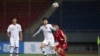 A handout photo taken Oct. 15, 2019, by the Korea Football Association (KFA) shows players fighting for the ball during a World Cup 2022 qualifying match between South Korea and North Korea at Kim Il Sung Stadium in Pyongyang.