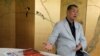 Hong Kong media tycoon Jimmy Lai gesture next to a copy of Apple Daily's July 1 edition during an interview Hong Kong, July 1, 2020.