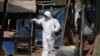 A member of the non-profit Cambodian Children's Fund sprays disinfectant to help curb the spread of the new coronavirus in the slum neighborhood of Stung Meanchey in southern Phnom Penh, Cambodia, March 24, 2020.