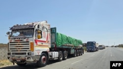 Egyptian trucks carrying humanitarian aid bound for the Gaza Strip wait near the Rafah border crossing on the Egyptian side on May 26, 2024, amid the ongoing conflict in the Palestinian territory between Israel and the Palestinian militant group Hamas.