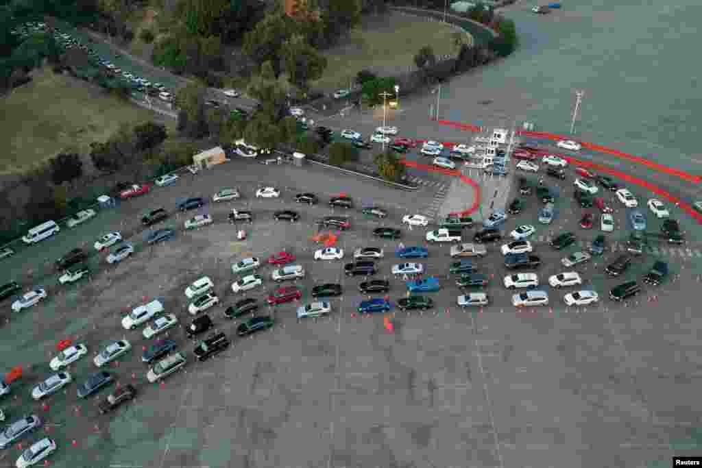 People line up in their vehicles at Dodger Stadium as post-Christmas COVID-19 testing resumes during a surge in positive coronavirus disease cases in Los Angeles, California, Dec. 29, 2020.