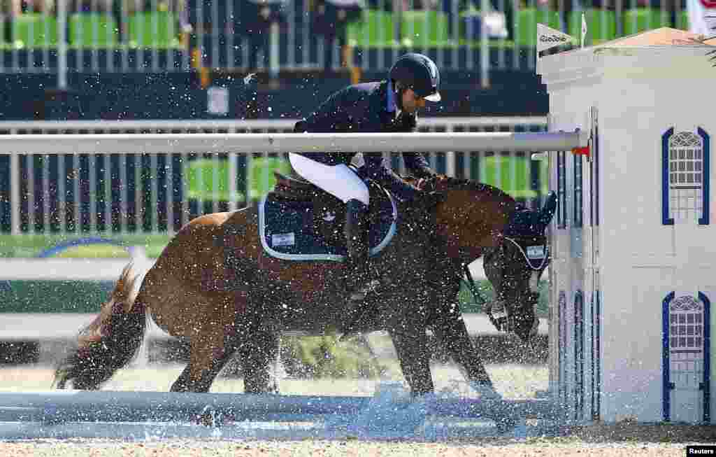 Ramiro Quintana (ARG) of Argentina riding Appy Cara fails to clear the obstacle during the Equestrian's Show Jumping individual qualification at the Olympic Equestrian Center in Rio de Janeiro, Brazil.
