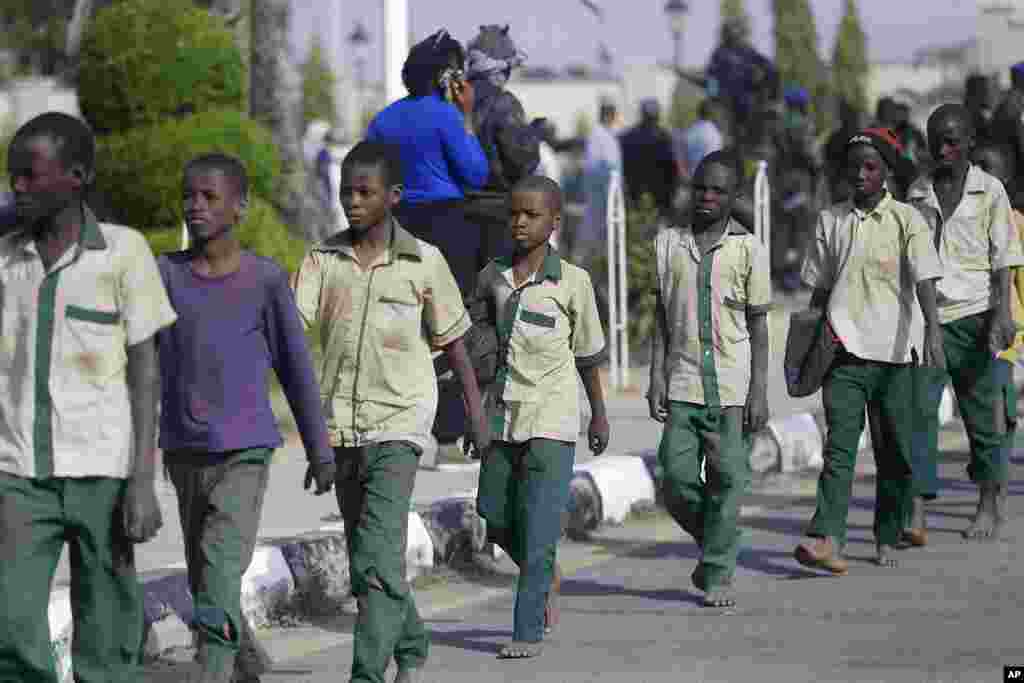 A group of schoolboys is escorted by Nigerian military and officials following their release after they were kidnapped last week, in Katsina, Nigeria.