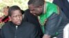 Then-acting President Edgar Lungu (l) talks to foreign affairs minister Harry Kalaba during a military exhibition march, Oct. 24, 2014 to mark Zambia's 50th Independence celebration. 