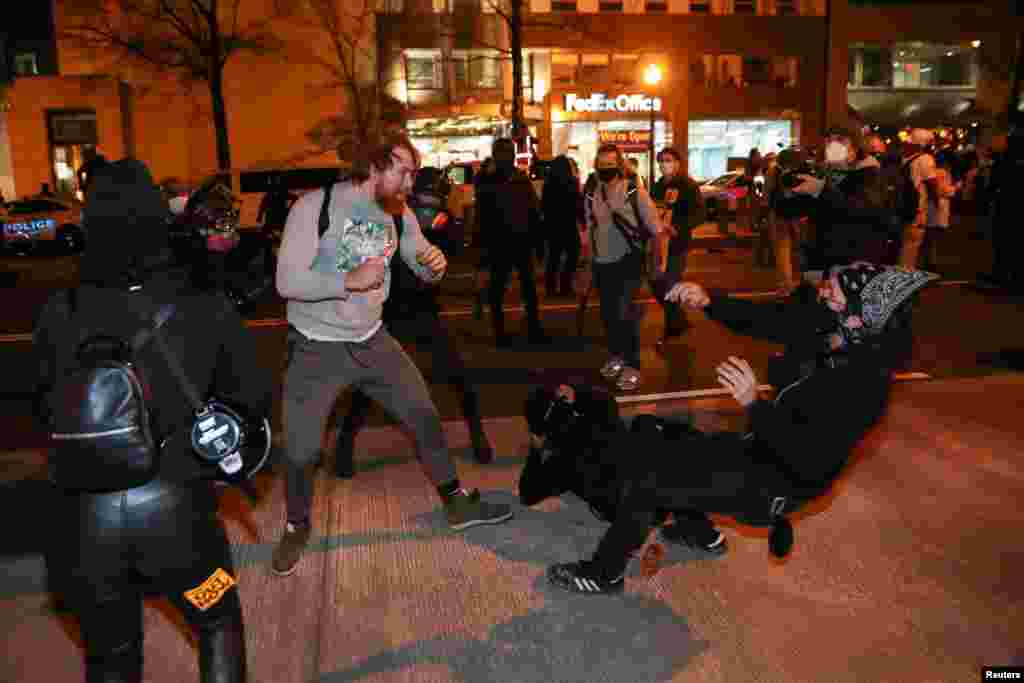 A supporter of U.S. President Donald Trump fights with counter protesters during a march in response to various pro-Trump rallies held throughout D.C., in Washington, Dec. 12, 2020.