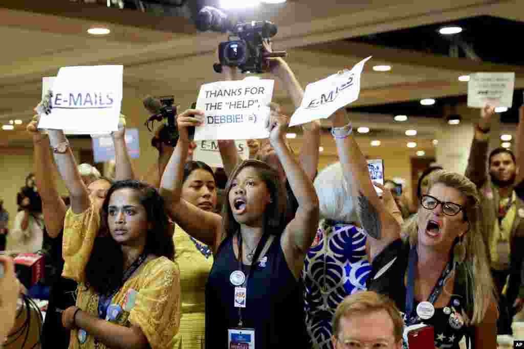 Protesters yell as DNC Chairwoman, Debbie Wasserman Schultz, D-Fla., arrives for a Florida delegation breakfast in Philadelphia, Pennsylvania, on the first day of the Democratic National Convention. She announced she would step down as DNC chairwoman at the end of the party's convention, after some of the 19,000 emails, presumably stolen from the DNC by hackers, were posted to the website Wikileaks.