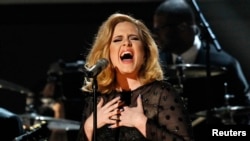 FILE - Adele performs "Rolling in the Deep" at the 54th annual Grammy Awards in Los Angeles, Calif.