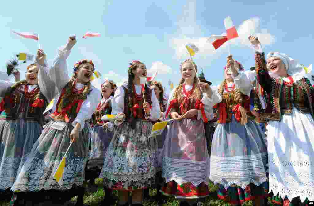 A group of folk dancers rehearse prior to the arrival of Pope Francis at the military airport in Krakow, Poland. Pope Francis is in Poland to meet young Catholics from around the globe and visit the Auschwitz death camp and many Catholic places in this deeply religious nation.