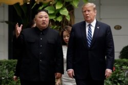 FILE - U.S. President Donald Trump and North Korean leader Kim Jong Un take a walk after their first meeting at the Sofitel Legend Metropole Hanoi hotel in Hanoi, Vietnam, Feb. 28, 2019.