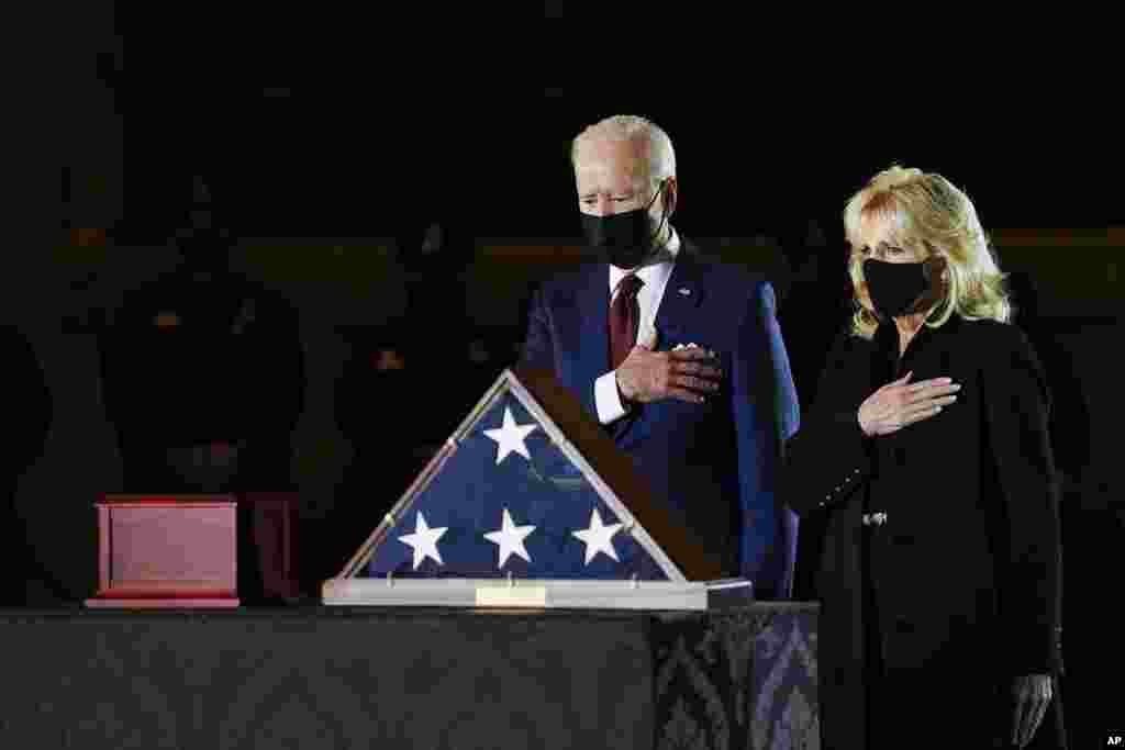 President Joe Biden and first lady Jill Biden pay their respects to the late U.S. Capitol Police officer Brian Sicknick as an urn with his cremated remains lies in honor on a black-draped table at center of Capitol Rotunda in Washington, Feb. 2, 2021.