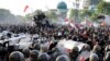 Riot police officers block students from advancing toward the local parliament during a rally in Surabaya, East Java, Indonesia, Sept. 26, 2019. 