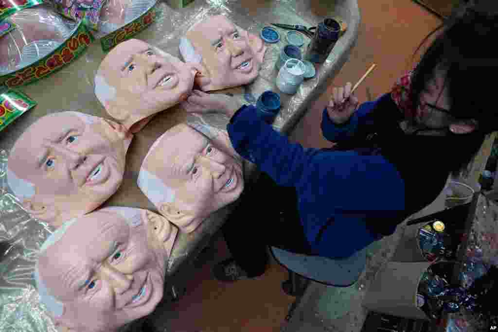 An employee adds details to rubber masks depicting President-elect Joe Biden at the Ogawa Studios in Saitama, north of Tokyo, Japan.