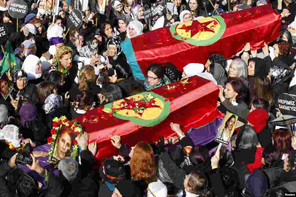 People carry the coffins of the Kurdish activists who were shot in Paris, during a funeral ceremony in Diyarbakir, Turkey, January 17, 2013.