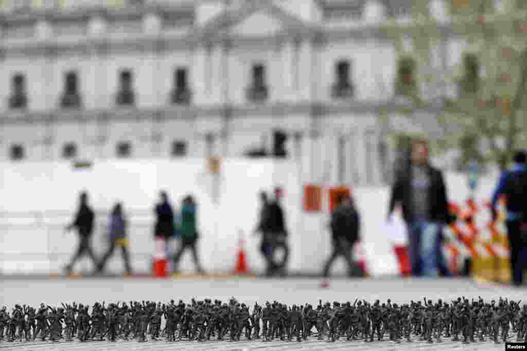 Toy soldiers are seen on the ground as part of an art installation in front of "La Moneda" Presidential Palace in Santiago, Chile.