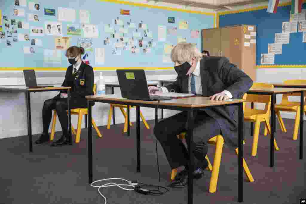 Britain's Prime Minister Boris Johnson takes part in an online class during a visit to Sedgehill School in Lewisham, south east London, to see preparations for students returning to school.