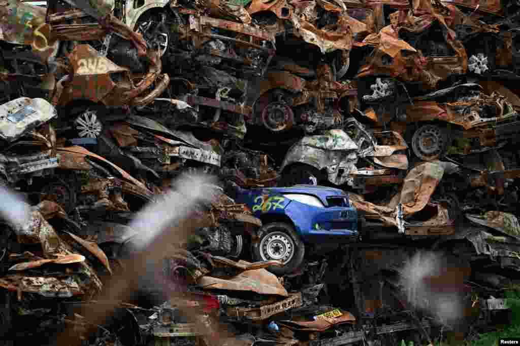 A collection of damaged cars lies abandoned since the deadly October 7 attack by gunmen from Palestinian militant group Hamas from the Gaza Strip, on a field near Netivot in southern Israel.