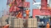 FILE - Workers load goods for export onto a crane at a port in Lianyungang, Jiangsu province, China, June 7, 2019. 