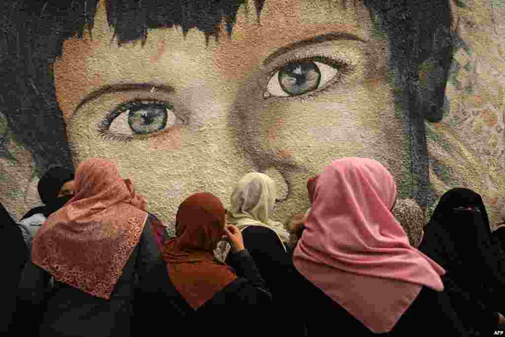 Palestinian women take part in a protest against the cuts in food aid distribution, outside the United Nations Relief and Works Agency headquarters in Gaza City.