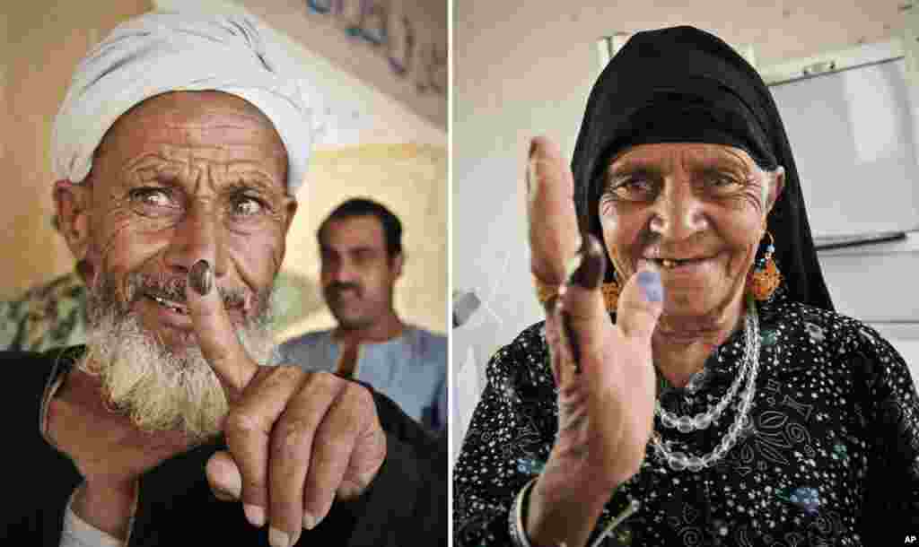 Egyptians show their inked fingers after casting their votes in Giza, Egypt.