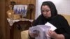 In this image from video, Zumret Dawut, a Uighur from China's far western Xinjiang region, holds documents she brought with her, at her new home in Woodbridge, Va., on Monday, June 15, 2020. Dawut says in China, she was forcibly sterilized for…