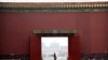 A visitor wearing a face mask to protect against the new coronavirus walks through the Forbidden City in Beijing, May 1, 2020. The Forbidden City reopened on Friday, China's May Day holiday, to limited visitors.