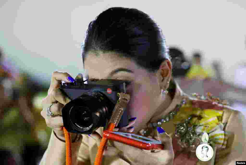 Thailand's Princess Sirivannavari Nariratana takes pictures after a religious ceremony to commemorate the death of King Chulalongkorn, known as King Rama V, at The Grand Palace in Bangkok, Thailand.