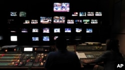 Employees of the Greece state broadcaster ERT in the control room at the television station's headquarters in Athens, June 12, 2013. 