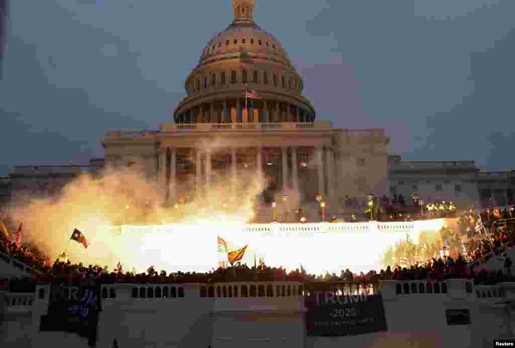 An explosion caused by a police munition is seen while supporters of U.S. President Donald Trump gather in front of the Capitol Building in Washington, D.C., Jan. 6, 2021.