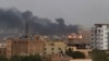 Smoke rises from the tarmac of Khartoum International Airport as a fire burns, in Khartoum