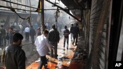 Damaged buildings along a street in the al-Khalidiya neighborhood of Homs, December 5, 2012.