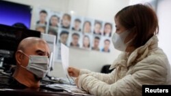 A software engineer works on a facial recognition system that identifies people when they wear a face mask at the development lab of the Chinese electronics manufacturer Hanwang (Hanvon) Technology in Beijing.