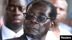 FILE - Zimbabwe President Robert Mugabe addresses supporters outside ZANU-PF headquarters.