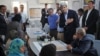 U.S. Secretary of State John Kerry, center right, greets a group of Syrian refugees during a joint meeting with Jordanian Foreign Minister Nasser Judeh, sitting at right, at the Zaatari refugee camp near Mafraq, Jordan, July 18, 2013.