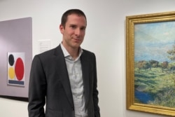 Scott Lynn, CEO and founder of Masterworks, poses next to artworks in New York, U.S., February 11, 2020.