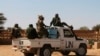 FILE - Chadian U.N. peacekeepers gesture as they patrol in Aguelhok, Mali, Jan. 24, 2014.