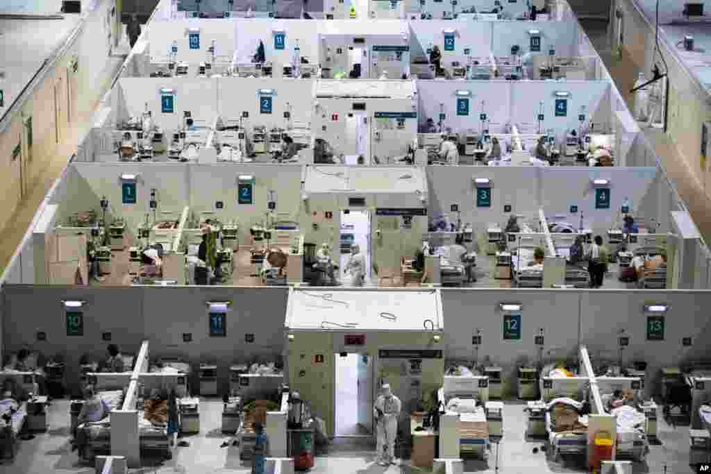 Medical workers and patients are seen in the treatment hall of a temporary hospital for coronavirus patients in the Krylatskoye Ice Palace in Moscow, Russia. 