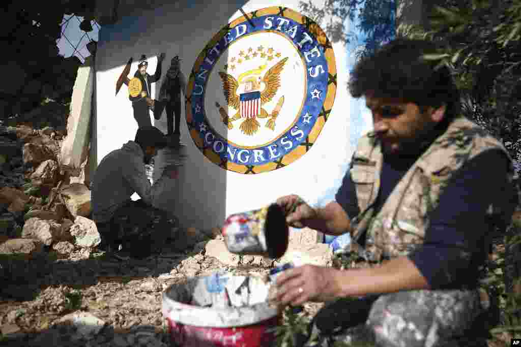 Syrian graffiti artist Aziz Al-Asmar finishes work on his depiction of the events in Washington after U.S. President Donald Trump's supporters stormed the Capitol, on a wall of a house destroyed in an airstrike, in Binish, Idlib province, Syria.