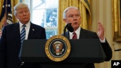 President Donald Trump listens as Attorney General Jeff Sessions speaks in the Oval Office of the White House in Washington, after Vice President Mike Pence administered the oath of office to Sessions. 