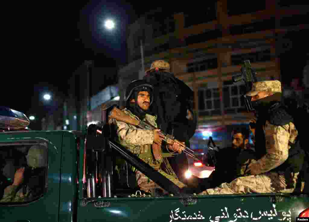 Afghan security personnel arrive near the Serena hotel, during an attack in Kabul, March 20, 2014.