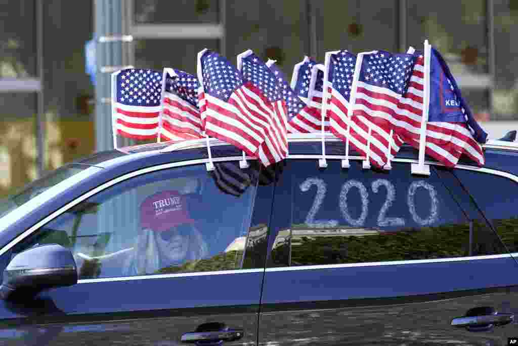 A protester joins a caravan outside of City Hall in Los Angeles. Demonstrators, supporting President Donald Trump, are gathering in various parts of Southern California as Congress debates to affirm President-elect Joe Biden's electoral victory.