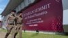 FILE - Thai policemen walk in front of a banner welcoming Association of Southeast Asian Nations in Nonthaburi province, Thailand, Oct. 29, 2019. 