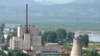 A North Korean nuclear plant is seen before demolishing a cooling tower (R) in Yongbyon, in this photo taken June 27, 2008 and released by Kyodo.