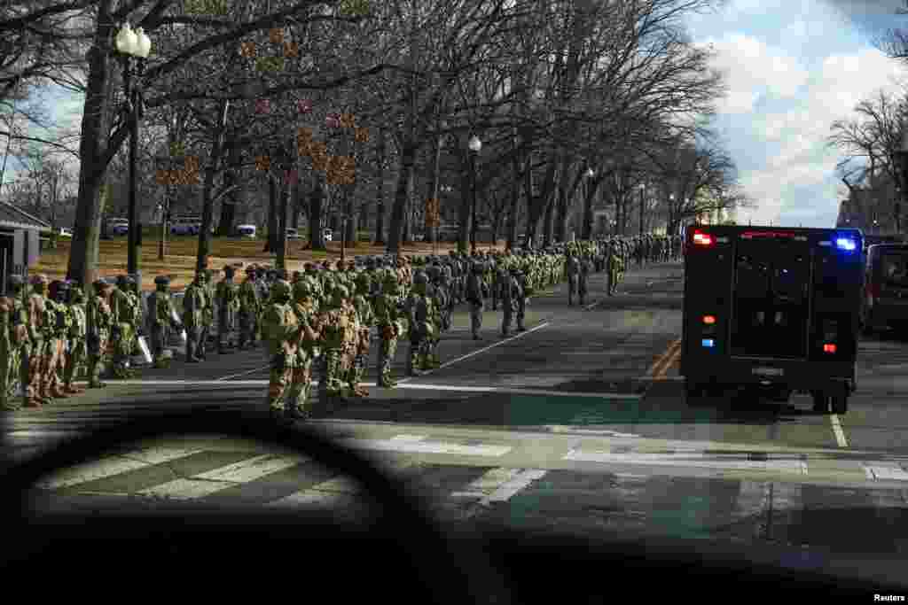 Military personnel standby along Pennsylvania Avenue as U.S. President-elect Joe Biden's motorcade arrives at the U.S. Capitol, in Washington.