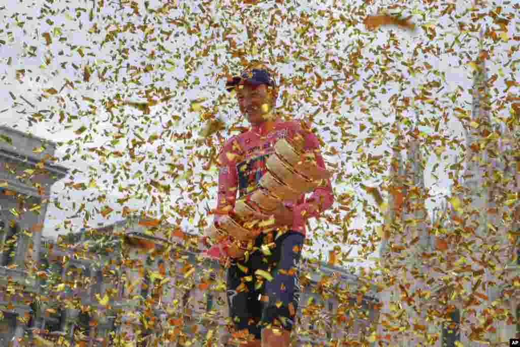 Britain's Tao Geoghegan Hart holds the trophy after winning the Giro d'Italia cycling race, in Milan, Italy.